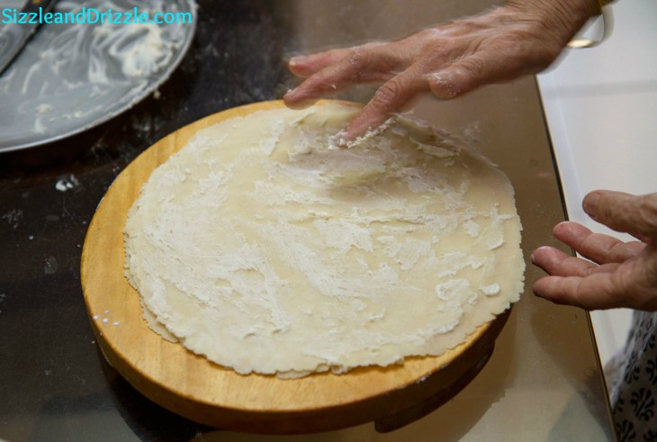 Slathering the rotis with a mixture of ghee and cornflour